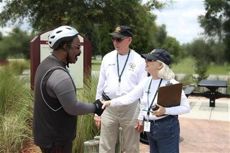 About Placeholder volunteers shaking hands with citizen